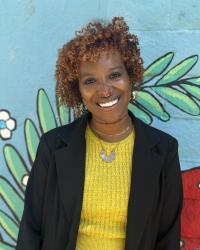 Photo of Brie taken against a blue, green, and red backdrop